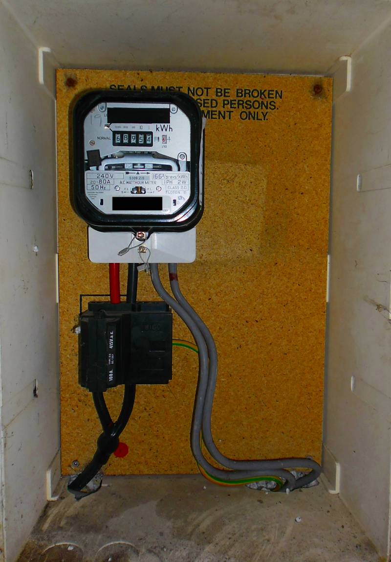 Inside the cupboard - the incoming supply, main fuse and analogue meter