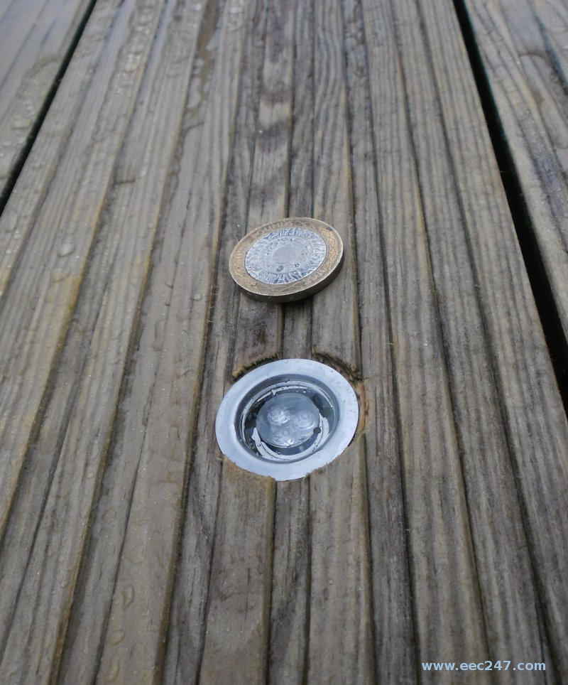 one of the LED deck lights compared to a two pound coin