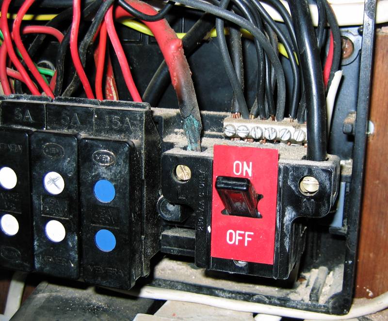 Burned out live cable to main switch inside a 1960s fusebox