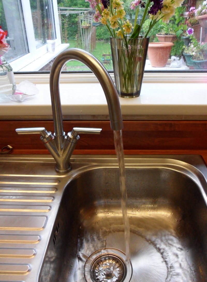 Kitchen taps in the on position with water running
