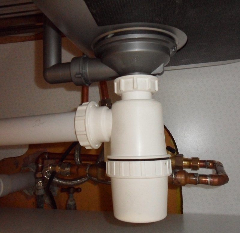 The electrically operated valves fit neatly behind the waste trap under the sink