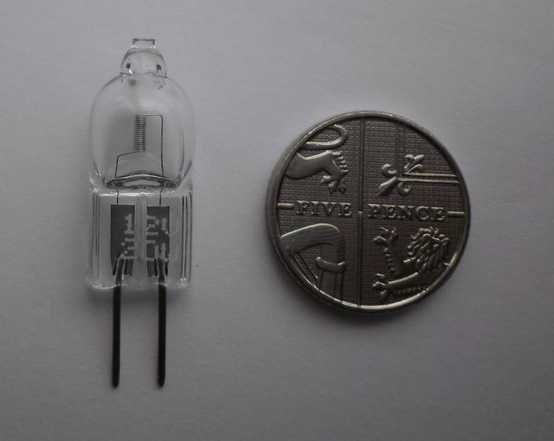 photograph of a halogen G4 capsule compared to a 5p coin